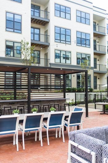 A patio with tables and chairs